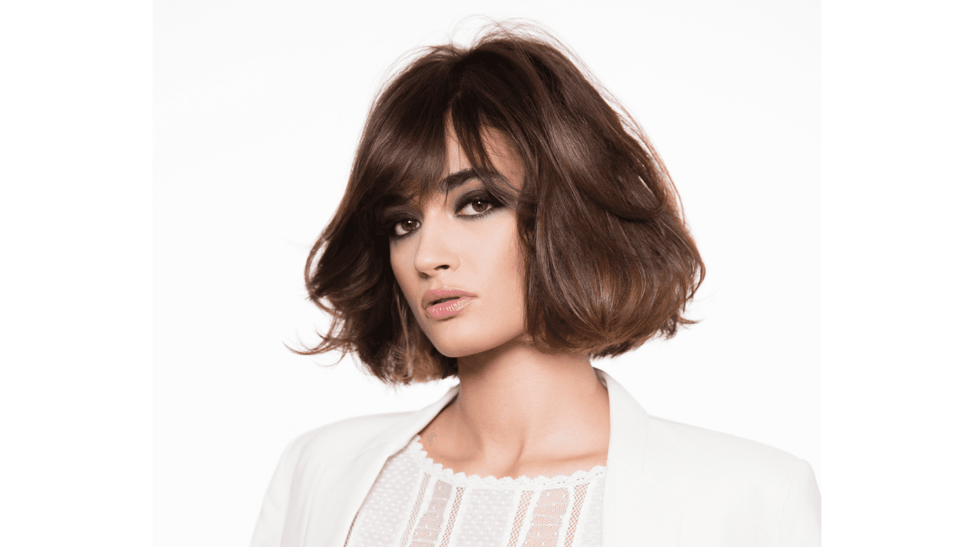 Confident woman over 40 with healthy, styled brunette hair, enjoying a relaxed moment after a haircut at Jayne Elliott Hair Company in Lutterworth.