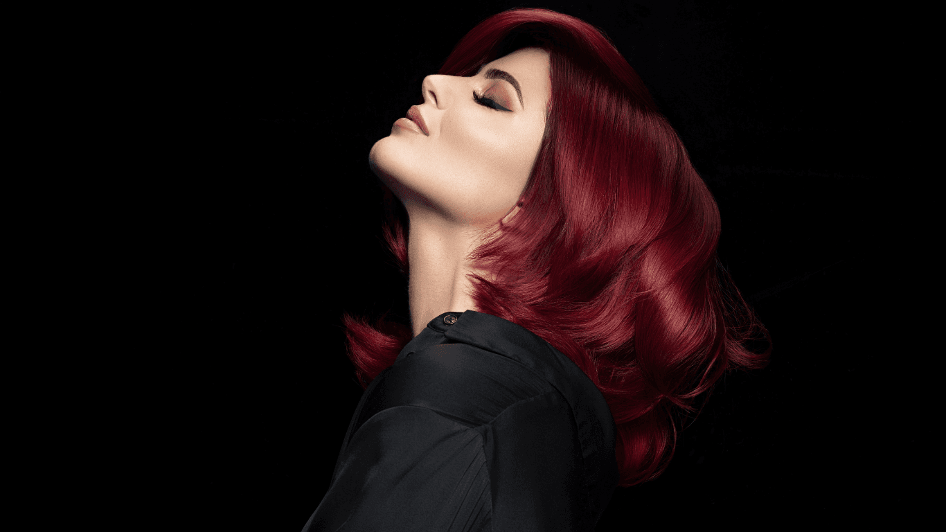 Striking rainbow hair colour featuring vivid red, yellow, blue and violet tones used as a blog header image for Jayne Elliott Hair Company in Lutterworth, showcasing artistic colour creativity.